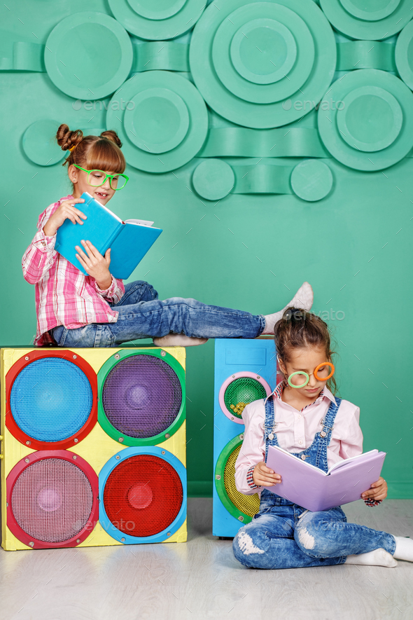 Two children read books in the glasses in the room. The concept - Stock Photo - Images