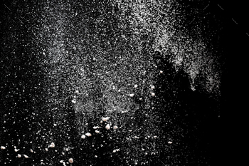 White powder explosion. White powder splash isolated on black background. Flour sifting on a dark