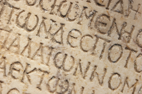 Close up of an ancient text carved on marble.