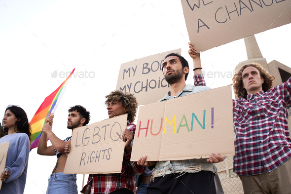 Group of activist people holding banners during LGBT social event.