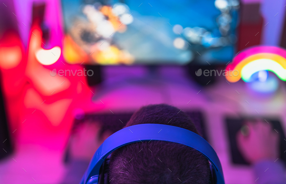 Young gamer playing online video games while streaming on social media - Stock Photo - Images