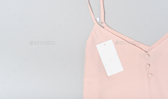 White clothing tag, label blank mockup template, to place your design. Premium cotton pink blouse