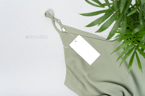 White clothing tag, label blank mockup, to place your design. Premium cotton khaki green blouse