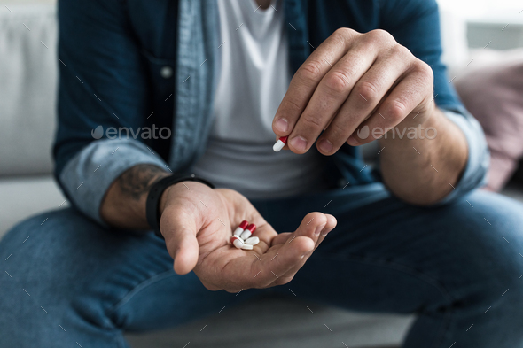 Colorful pharmaceutical medicine pills, narcotic drugs in capsules on palm - Stock Photo - Images