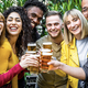 Multicultural group friends drinking and toasting beer glasses at brewery bar restaurant - PhotoDune Item for Sale