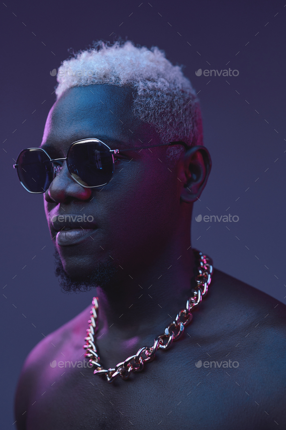 Nude african guy with white hairs against dark background Stock Photo