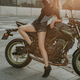 Woman with slim figure and dark motorbike outside - PhotoDune Item for Sale