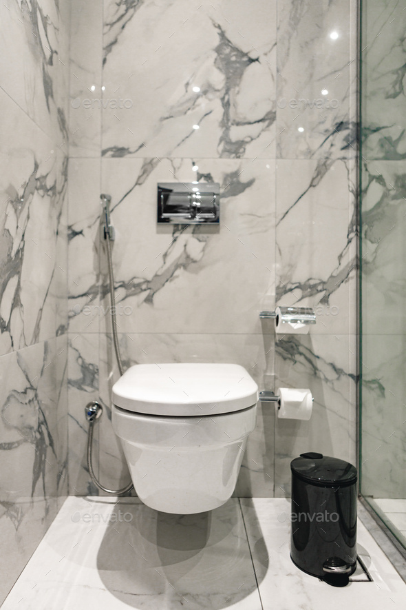 Toilet bowl near shower stall in modern bathroom interior Stock Photo ...