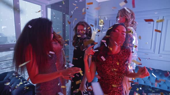 Party Beautiful Glamour Females in Dresses Wearing Protective Masks and Dancing in the Night Club alt