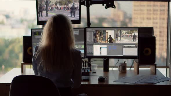 Female Video Editor Work With Footage In Post Production Company. Woman Video Editor On TV Station. alt