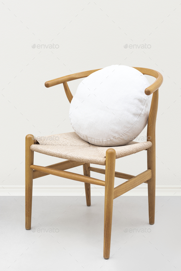 Linen cushion cover in white on a chair