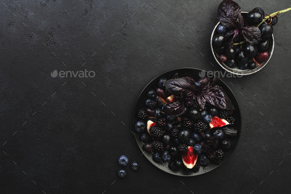 Autumn blue and black berries fruit vegan salad: blueberries, blackberries, grapes, figs