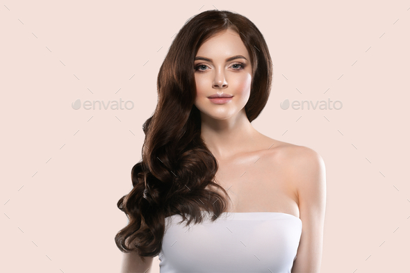 Beautiful hair skin woman portrait natural make up long curly hair. Color background yellow