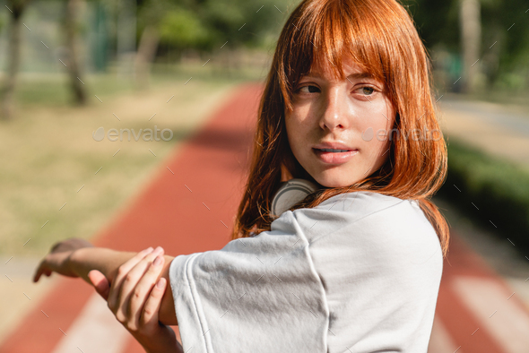 Close-up of beautiful young Caucasian female athlete exercising