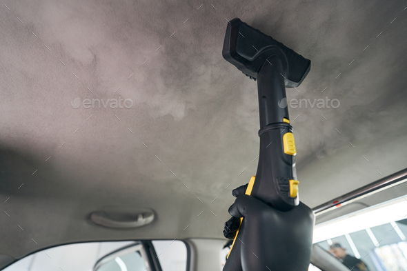 Steam cleaner of car interior. Vapor sterilization. Salon dry cleaning  Stock Photo by svitlanah