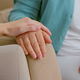 Caregiver cheers up senior lady patient touching hand while sits in armchairs in light room - PhotoDune Item for Sale