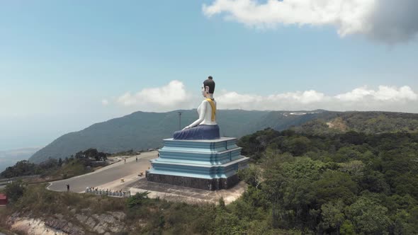 Mountainous landscape Parallaxing with Big Buddha Statue in the Bokor Mountains of Kampot, Cambodia alt