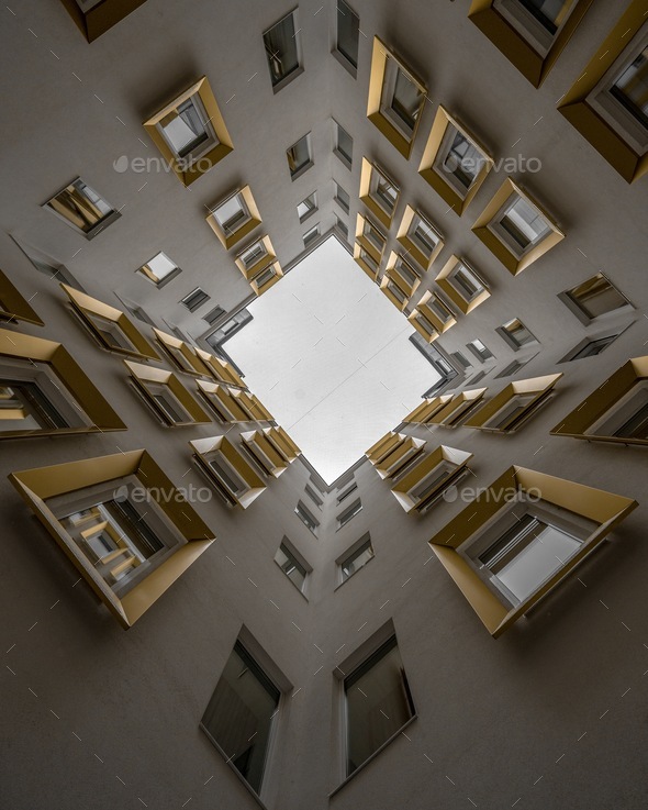 Vertical low angle view of high ceiling building with golden win - Stock Photo - Images