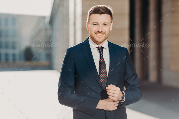 Elegant handsome man in classical suit poses near wooden fence - Stock  Image - Everypixel