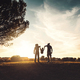 Silhouette of happy family walking in the meadow at sunset - PhotoDune Item for Sale
