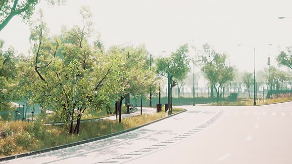 Empty Asphalt Road and Beautiful View of Cityscape on Sunny Day alt