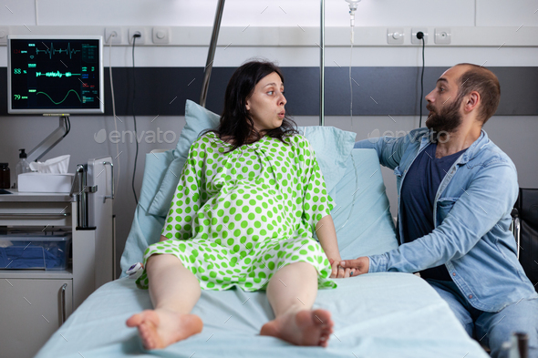 Young couple with pregnancy preparing for child delivery