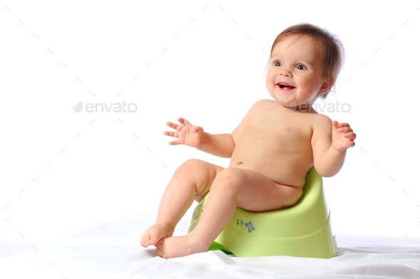 Funny baby sitting on green potty