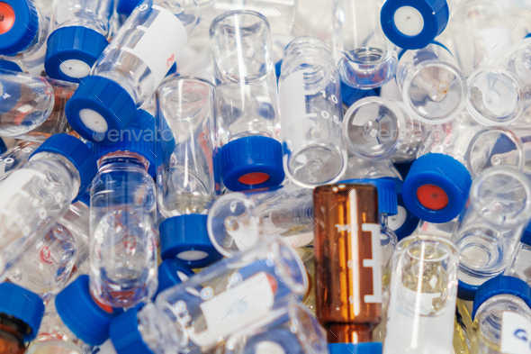 Dirty used chromatographic vials with blue caps. HPLC analysis at analytical chemistry laboratory