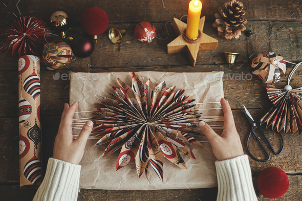 Christmas angel, stars, pine cones, candle, thread, scissors on rustic  wood. Handmade scandi decor Stock Photo by Sonyachny