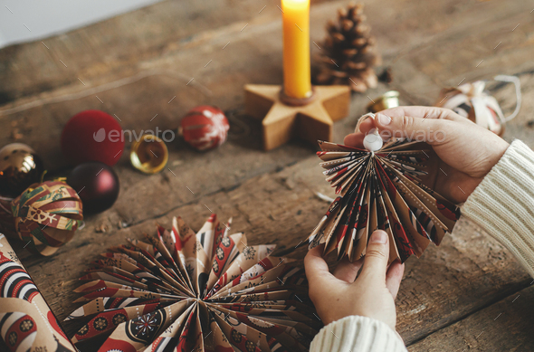 Christmas angel, stars, pine cones, candle, thread, scissors on rustic  wood. Handmade scandi decor Stock Photo by Sonyachny