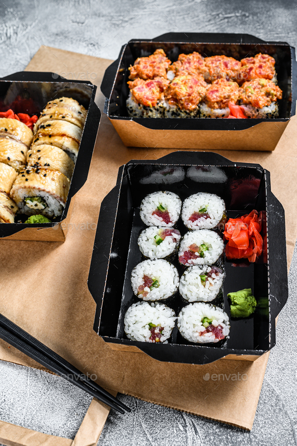 The sushi rolls in the delivery package, ordered in sushi take-out restaurant.