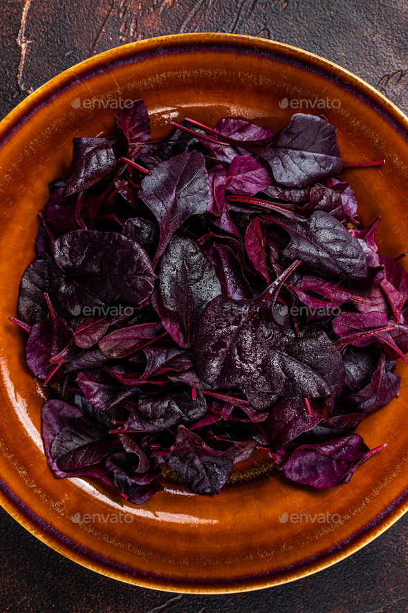 Raw Ruby or red chard salad Leafs on a rustic plate. Dark background. Top view