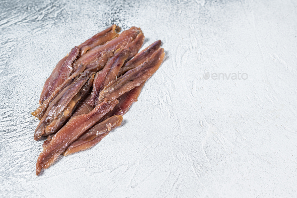 Canned Anchovies fish fillet in Olive Oil. White background. Top view. Copy space
