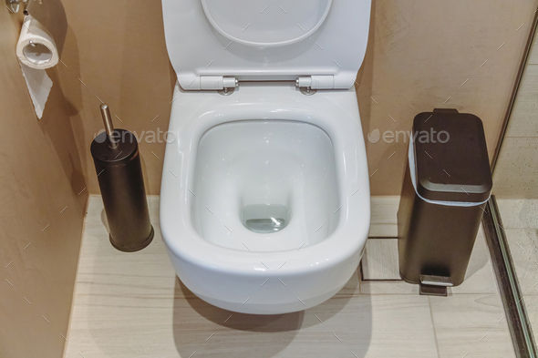 Modern toilet interior design, hanging toilet bowl and brush, beige