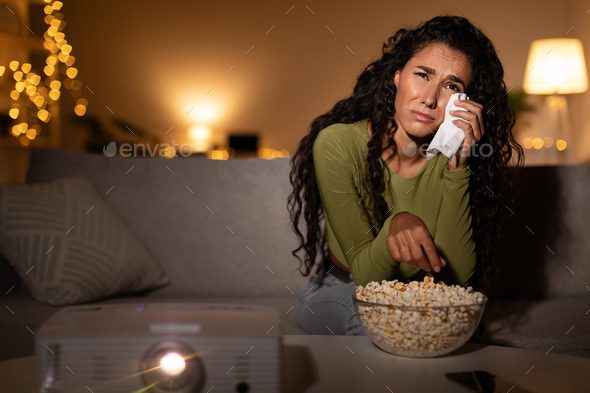 Woman Crying Watching Sad Movie Sitting On Sofa At Home