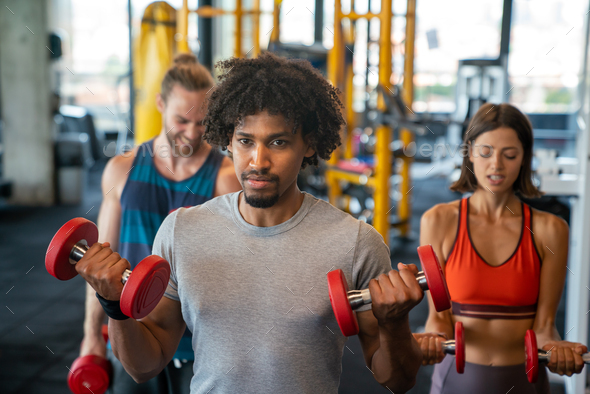 Happy diverse people exercise together in gym to stay healthy Stock ...