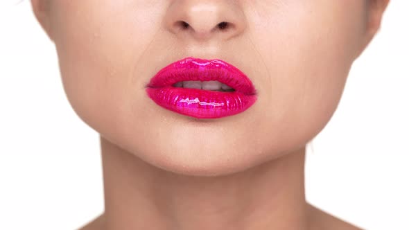 Extreme Close Up Portrait of Seductive Female Person 30s Biting Her Lower Lip Covered with Pink alt