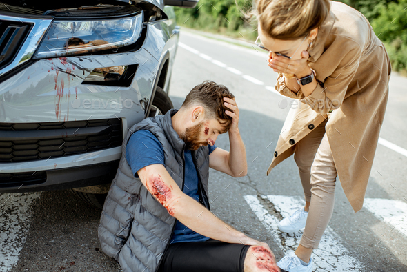 Woman driver with injured man on the road
