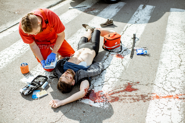 Medic applying emergency care after the road accident