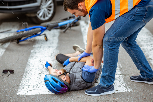 Road accident with injured cyclist and car driver