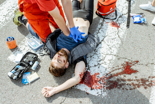 Medic applying emergency care after the road accident