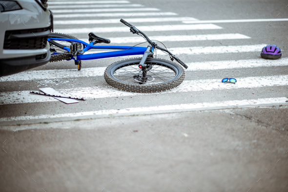 Road accident with car and broken bicycle
