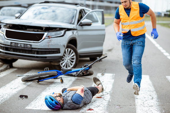 Road accident with injured cyclist and car driver