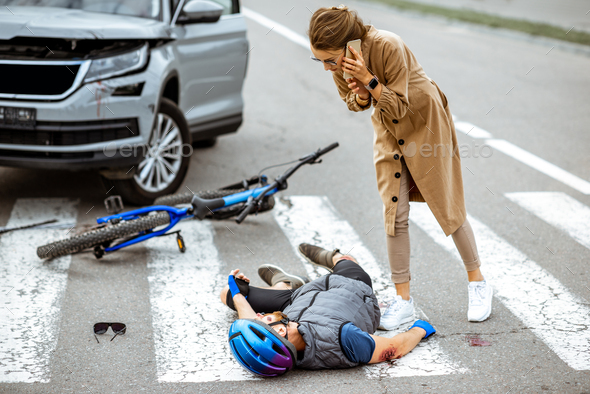 Road accident with injured cyclist and woman driver