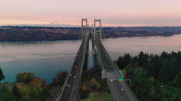 An aerial perspective of weather rolling into te Narrows Bridges in Washington State