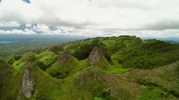 Aerial view of peak Chocolate hills and cloudy sky in Badian, Philippines. alt