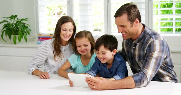 Happy family using digital tablet alt