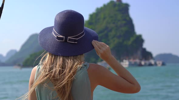 A Young Woman Tourist Visits the Halong Bay National Park in Vietnam Consisting of Thousands of alt