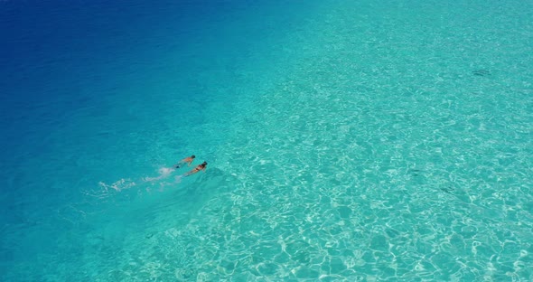 Couple snorkeling together in paradise alt