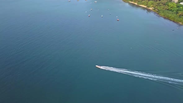 A dynamic tracking footage of a fast boat coming from a jetty in Ma On Shan town, Hong Kong. The spe alt